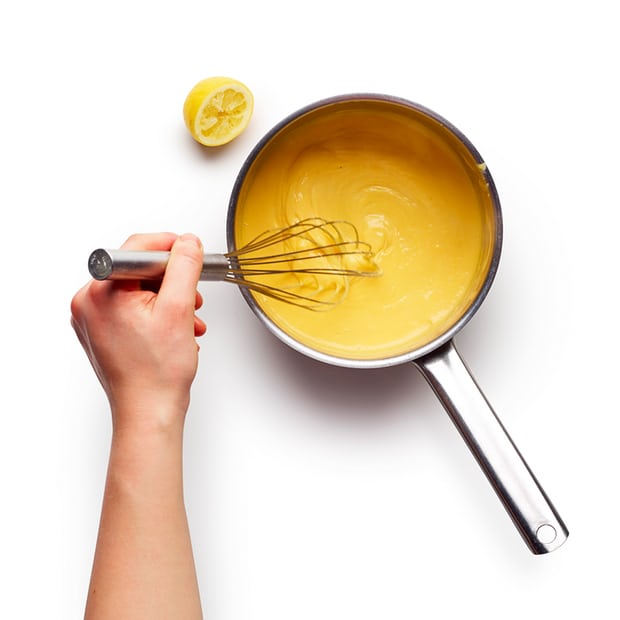 Once the butter and eggs have emulsified, swap the spoon for a whisk and beat until the sauce thickens.